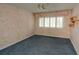 Bedroom with floral wallpaper, blue carpet, and window shutters at 497 Oak Haven Dr, Altamonte Springs, FL 32701