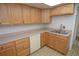 Bright kitchen with oak cabinets, tile floor, and stainless steel sink at 497 Oak Haven Dr, Altamonte Springs, FL 32701