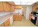 Kitchen with light wood cabinets, pink countertops, and appliances at 497 Oak Haven Dr, Altamonte Springs, FL 32701