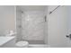 Clean bathroom featuring a marble shower and modern toilet at 5019 Nassau Cir # 5, Orlando, FL 32808