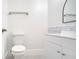 Clean bathroom with white vanity, leaf-patterned backsplash, and a modern mirror at 5019 Nassau Cir # 5, Orlando, FL 32808