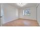 Spacious bedroom with wood-look flooring and a window offering natural light at 5019 Nassau Cir # 5, Orlando, FL 32808
