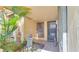 Front entry with a brick walkway, tropical plants, and a bird bath at 5019 Nassau Cir # 5, Orlando, FL 32808