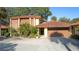 Exterior view of a two-story house with a brown tile roof and attached garage at 5019 Nassau Cir # 5, Orlando, FL 32808