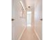 Light and bright hallway with wood-look flooring, leading to bedrooms and bathroom at 5019 Nassau Cir # 5, Orlando, FL 32808