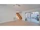 Open living space with light wood floors, sliding glass doors to a patio, and a staircase at 5019 Nassau Cir # 5, Orlando, FL 32808