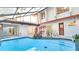 Inviting swimming pool surrounded by lush landscaping and a covered patio at 5019 Nassau Cir # 5, Orlando, FL 32808