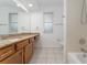 Bathroom with granite countertop, wood cabinets, and tiled floors at 5100 Neponset Ave, Orlando, FL 32808