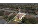 Aerial view highlighting a two-story house in a residential area at 533 Woods Landing Dr, Minneola, FL 34715