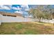 Private backyard with a grassy area and white fence at 533 Woods Landing Dr, Minneola, FL 34715