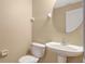 Small bathroom with pedestal sink and toilet at 533 Woods Landing Dr, Minneola, FL 34715