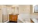 Bathroom with shower, corner tub, and wood cabinets at 533 Woods Landing Dr, Minneola, FL 34715