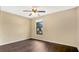 Bedroom with dark wood floors and ceiling fan at 533 Woods Landing Dr, Minneola, FL 34715