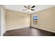 Bright bedroom with dark wood floors and ceiling fan at 533 Woods Landing Dr, Minneola, FL 34715