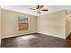 Well-lit bedroom featuring dark wood floors and a ceiling fan at 533 Woods Landing Dr, Minneola, FL 34715