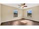 Spacious bedroom with two windows and a ceiling fan at 533 Woods Landing Dr, Minneola, FL 34715