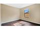 Bright bedroom with dark wood floors and a window at 533 Woods Landing Dr, Minneola, FL 34715