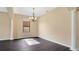 Bright dining room with dark laminate floors and chandelier at 533 Woods Landing Dr, Minneola, FL 34715