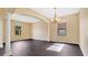 Bright dining room with dark laminate floors and chandelier at 533 Woods Landing Dr, Minneola, FL 34715