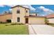 Two-story house with attached garage and landscaped lawn at 533 Woods Landing Dr, Minneola, FL 34715