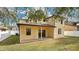 Back of house with covered patio and fenced yard at 533 Woods Landing Dr, Minneola, FL 34715