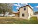 Two-story house with tan siding and a covered patio at 533 Woods Landing Dr, Minneola, FL 34715
