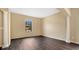 Spacious living room with dark laminate floors and columns at 533 Woods Landing Dr, Minneola, FL 34715