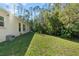Large grassy backyard with trees and bird bath at 562 Eagle Pointe S, Kissimmee, FL 34746