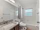 Clean bathroom with granite countertop, single sink, tub, and shower at 562 Eagle Pointe S, Kissimmee, FL 34746