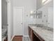 Bathroom with granite countertop, single sink, and toilet at 562 Eagle Pointe S, Kissimmee, FL 34746