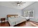 Spacious bedroom with king-size bed and extra twin bed, hardwood floors, and large window at 562 Eagle Pointe S, Kissimmee, FL 34746