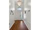 Bright entryway with hardwood floors and chandelier at 562 Eagle Pointe S, Kissimmee, FL 34746