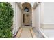 Arched entryway with tan door and neutral colored walkway at 562 Eagle Pointe S, Kissimmee, FL 34746