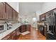 Spacious kitchen with granite countertops and dark wood cabinets at 562 Eagle Pointe S, Kissimmee, FL 34746
