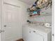 Laundry room with washer, dryer, and shelving at 562 Eagle Pointe S, Kissimmee, FL 34746