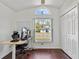 Home office with a large window, desk and two chairs at 562 Eagle Pointe S, Kissimmee, FL 34746