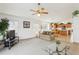 Bright living room with open floor plan, featuring a view of the kitchen and access to the backyard at 645 Rochester Loop, Davenport, FL 33897