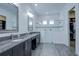 Modern bathroom with double vanity, large shower, and walk-in closet at 7901 Dausset St, Orlando, FL 32827