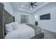 Spacious primary bedroom with ensuite bathroom and large TV at 7901 Dausset St, Orlando, FL 32827