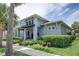 Curb appeal abounds in this beautiful 2-story home, featuring a landscaped yard and inviting front porch at 7901 Dausset St, Orlando, FL 32827