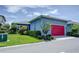 Single Gathering home with red garage door and landscaped yard at 7901 Dausset St, Orlando, FL 32827