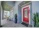 Elegant red front door welcomes you to this stunning home with a charming covered porch at 7901 Dausset St, Orlando, FL 32827