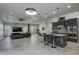 Spacious kitchen boasts a large island, dark cabinetry, granite countertops, and stainless steel appliances at 7901 Dausset St, Orlando, FL 32827