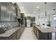 Open concept kitchen with large island, stainless steel appliances, and ample counter space at 7901 Dausset St, Orlando, FL 32827