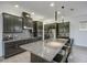 Modern kitchen with granite countertops, dark wood cabinetry, and a large island at 7901 Dausset St, Orlando, FL 32827