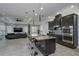 Gourmet kitchen with dark cabinetry, granite countertops, large island with seating, and top-of-the-line appliances at 7901 Dausset St, Orlando, FL 32827