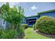 Landscaped yard with lush green grass and flowering bushes at 7901 Dausset St, Orlando, FL 32827