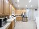 Modern kitchen with light wood cabinets and stainless steel appliances at 9007 Eagle Cove Ct, Orlando, FL 32825