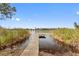 Wooden dock extending over calm lake water, offering peaceful waterfront views at 9511 Lake Douglas Pl, Orlando, FL 32817