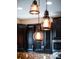 Pendant lights above kitchen island with dark cabinets at 998 Nathan Ridge Rd, Clermont, FL 34715